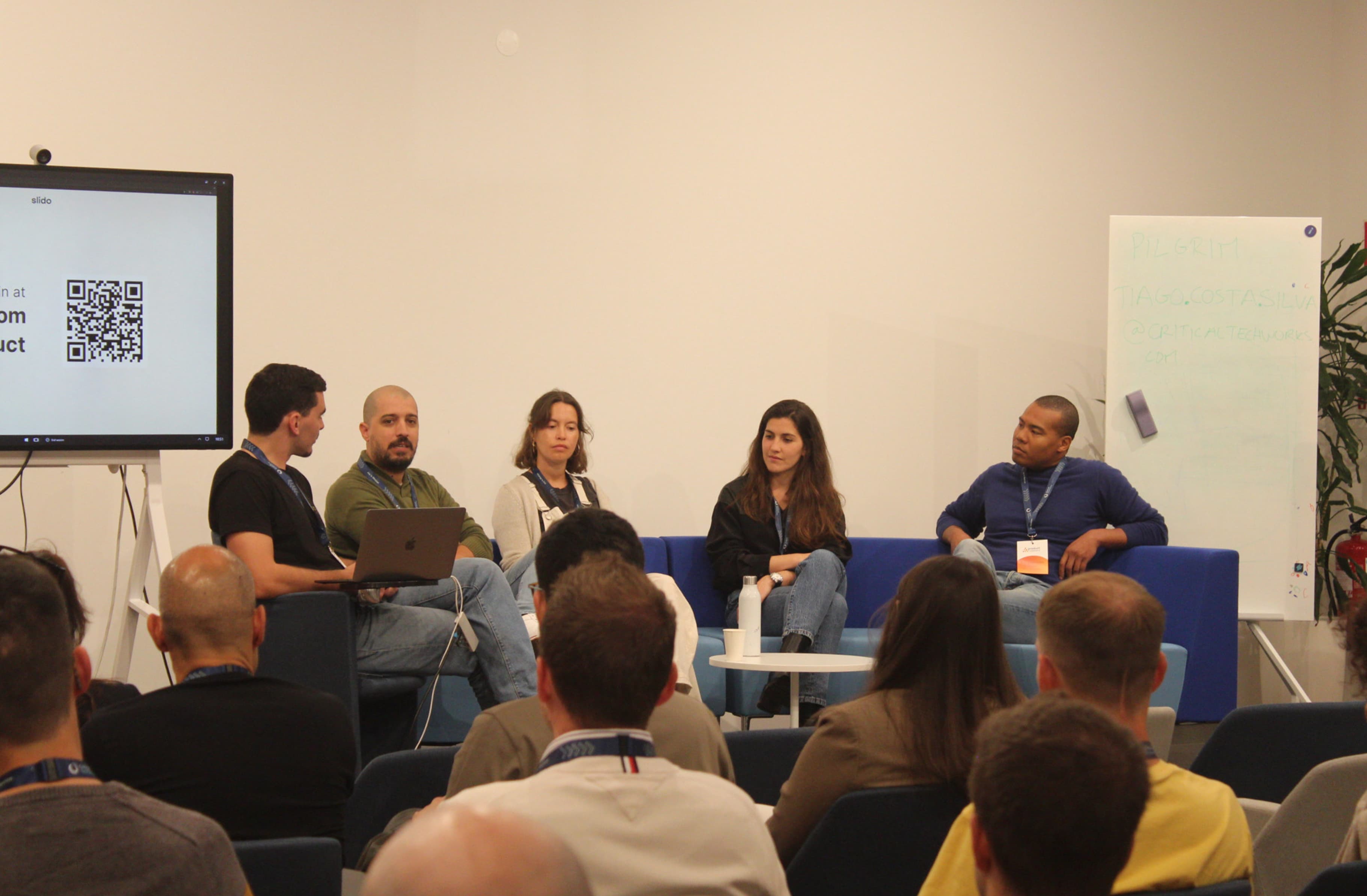 Panel discussion in a large room during a Product Circle event.